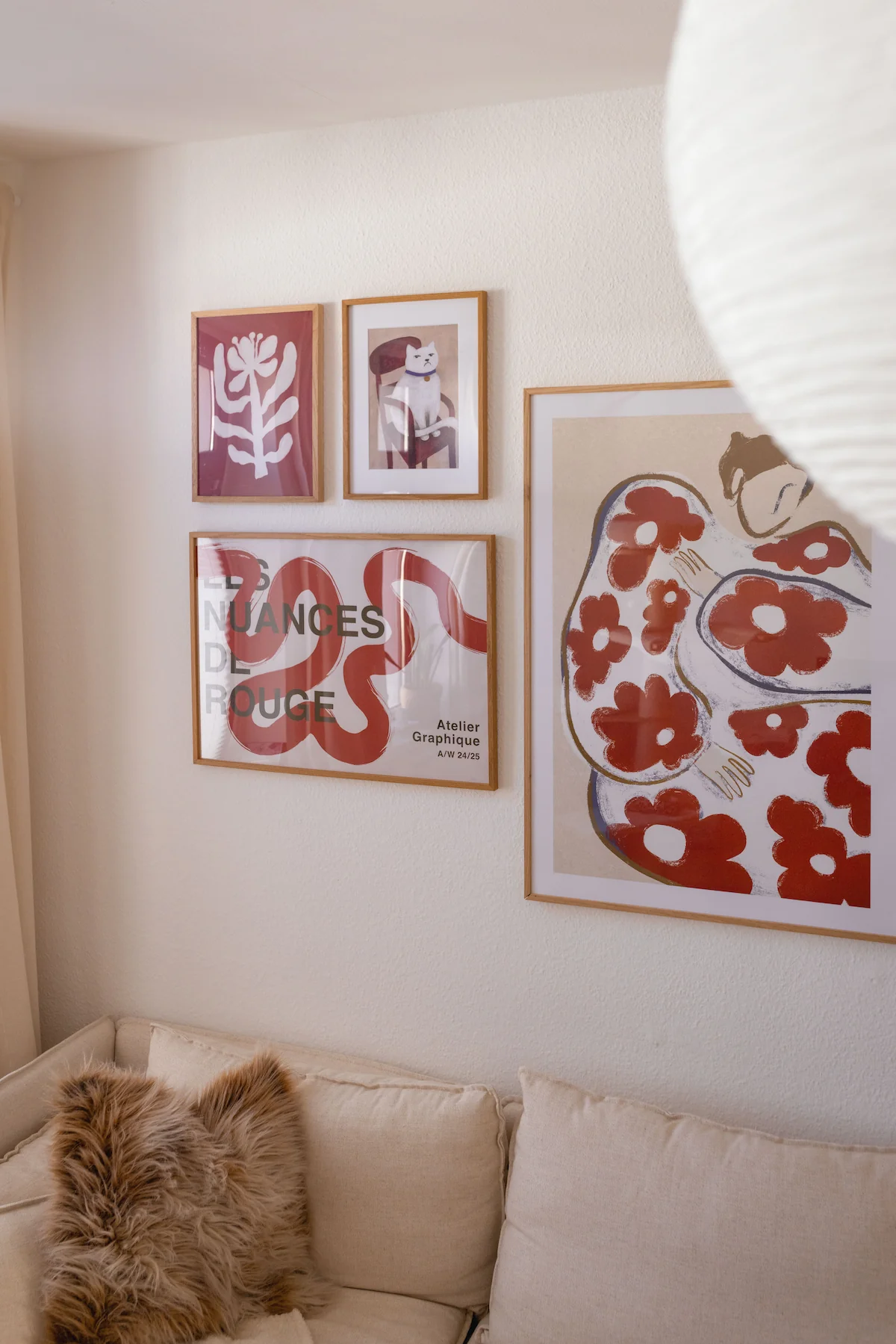 Minimalist line art posters in wooden frames as part of an abstract gallery wall