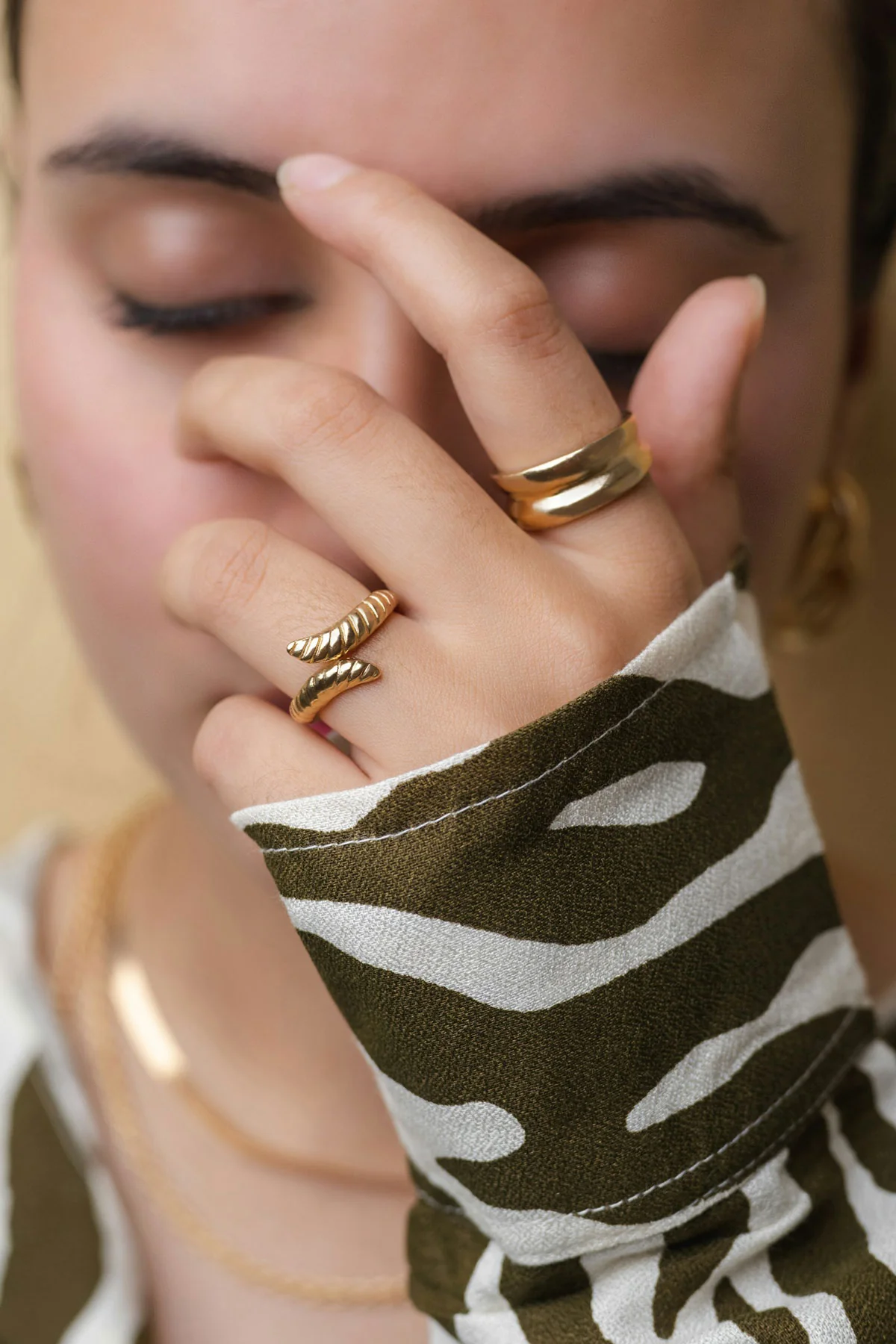 Zarte Goldringe kombiniert zu schlichtem Alltagsoutfit mit natürlichem Styling.