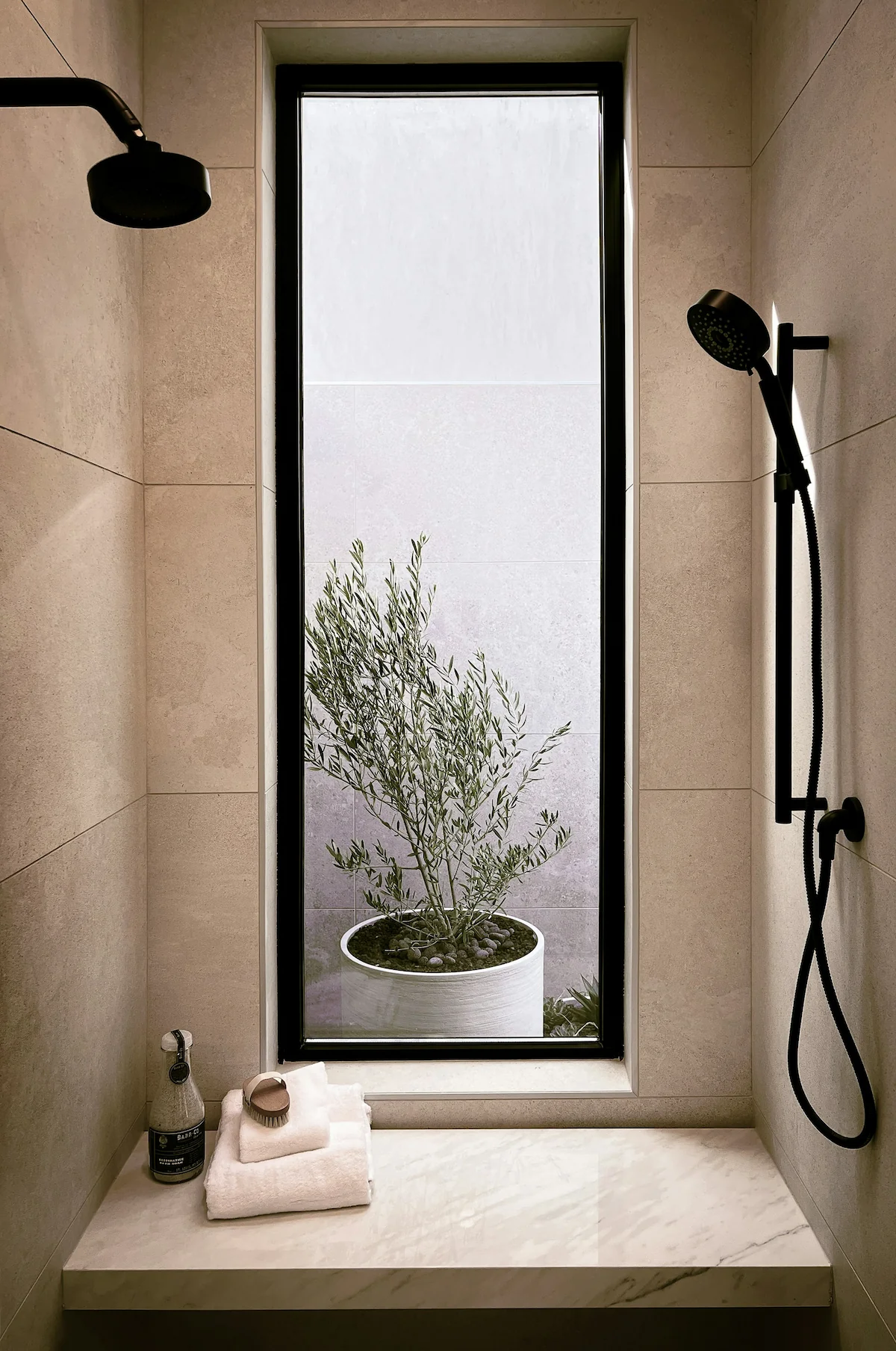 Atmospheric lighting in a comfortably furnished bathroom.